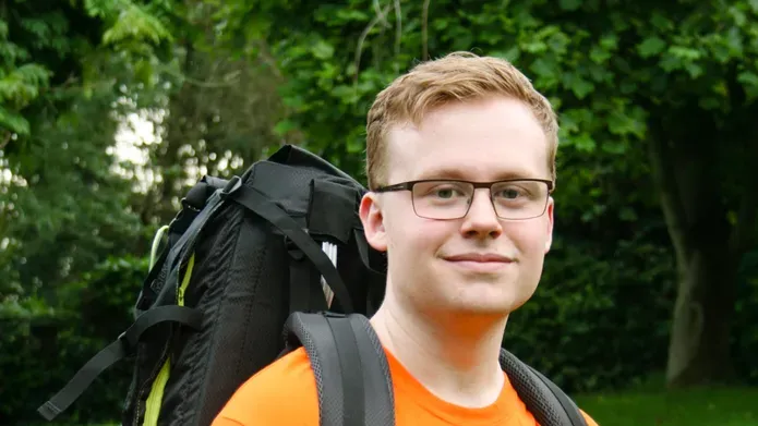 Student Curtis Large wearing a hiking backpack