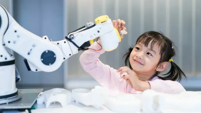 Girl interacting with robotic arm