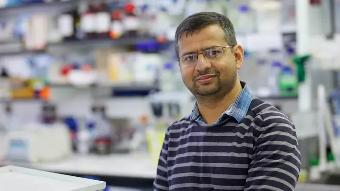 Gopal Sapkota stood in a lab