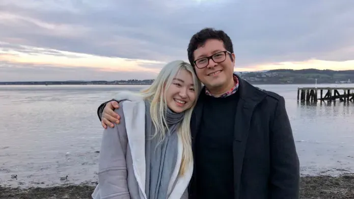 A couple hugging in front of the Firth of Tay
