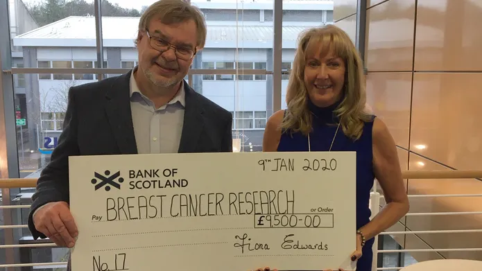 Prof Andy Evans receives cheque from Fiona Edwards