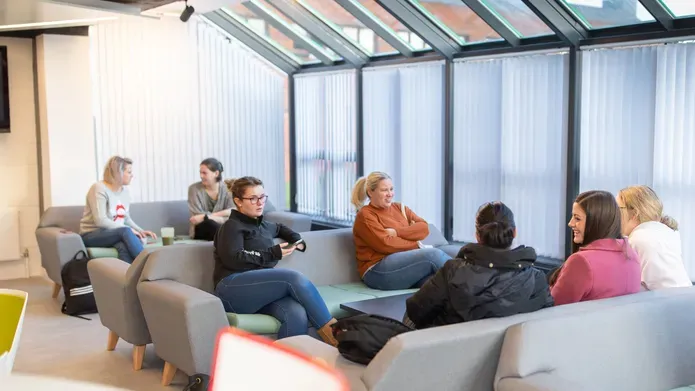 People sitting on grey sofas
