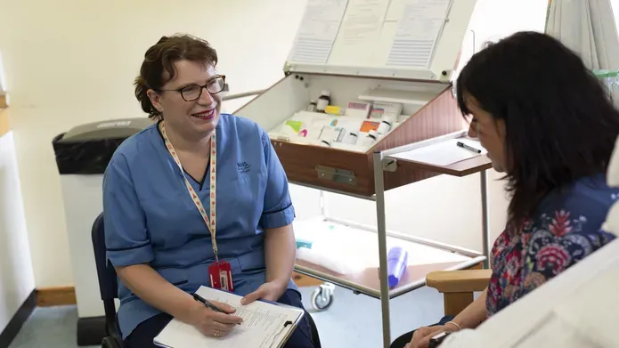 Nursing student in classroom with "patient"