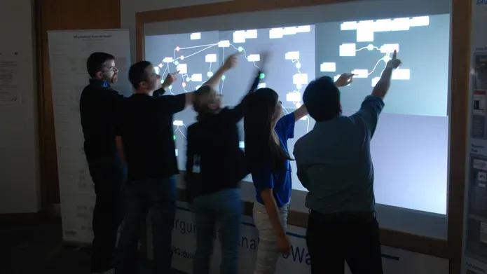 people working on a screen together
