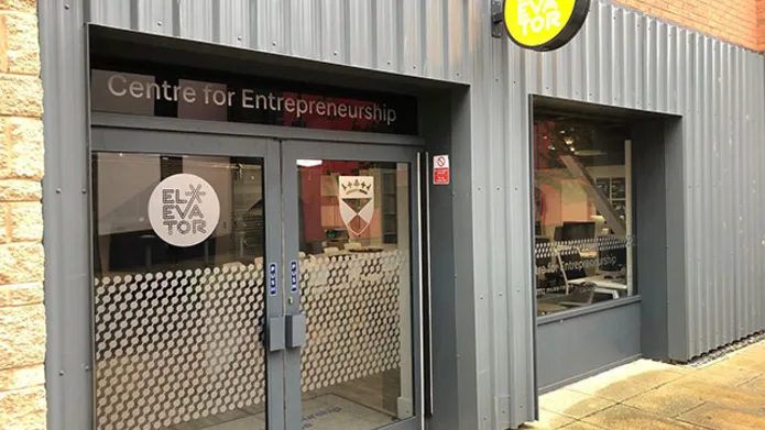 a grey shop front with double glass doors