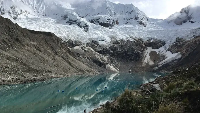 Snow capped mountains around a frozen lake