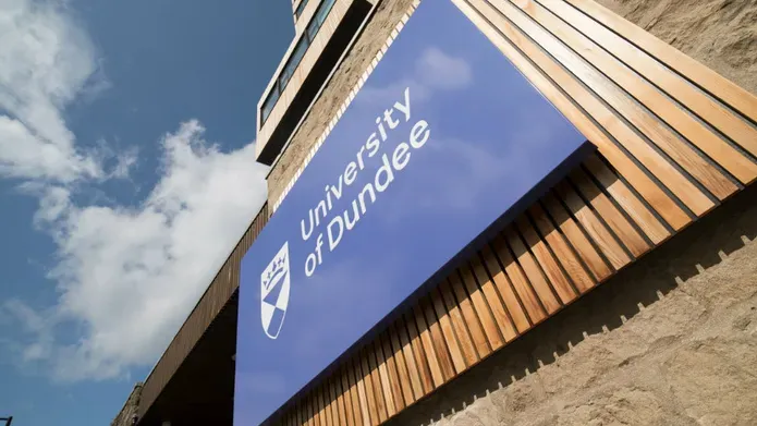 UoD sign with blue sky and clouds