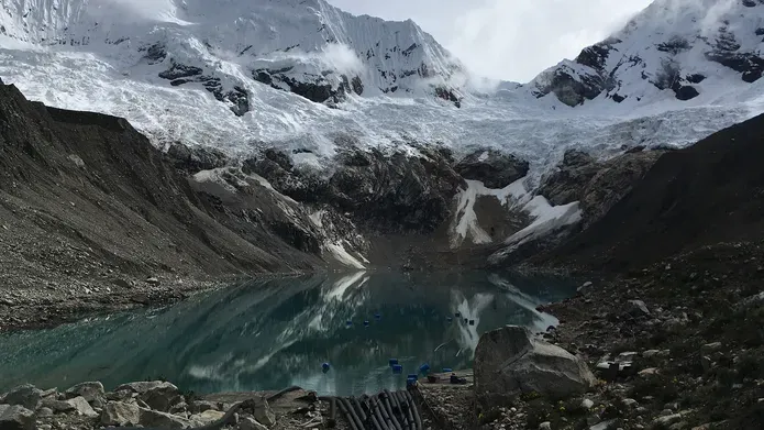 Melting glacier with a lake at the bottom of a valley