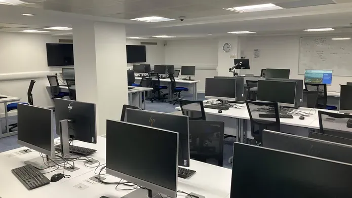 IT Suite in the Tower Basement showing several rows of computer screens on white desks