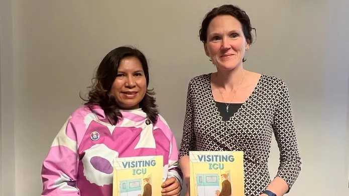 Mayra Crowe and Dr Pauline Austin, coordinators of the project, holding the Visiting ICU comic