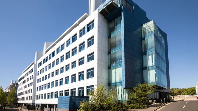 Sir James Black Centre a six story white and blue building on the Dundee city campus