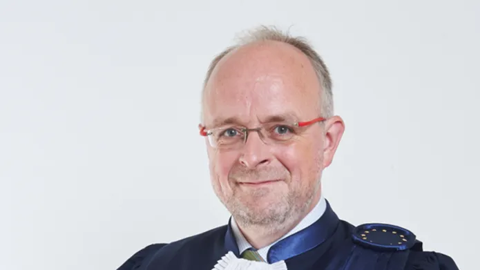 Tim Eicke wearing blue gown