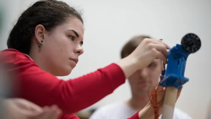 student working on a mechanical device