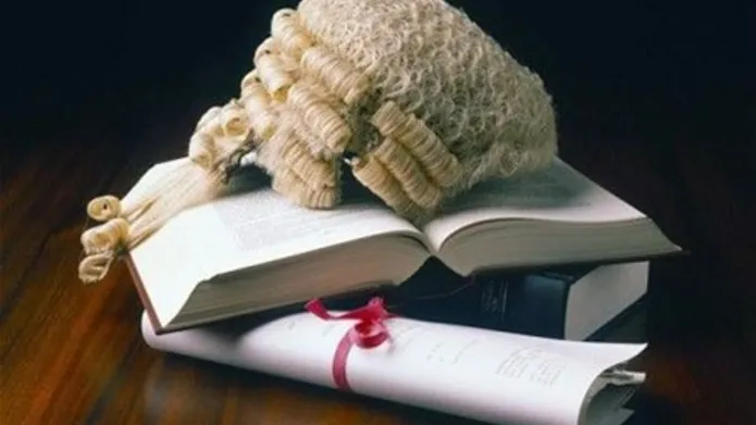 Judges wig sitting on a pile of books
