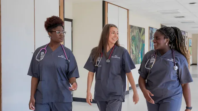 Three medical students wearing scrubs at the University of Dundee School of Medicine