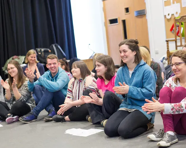 A group of people sitting on the floor