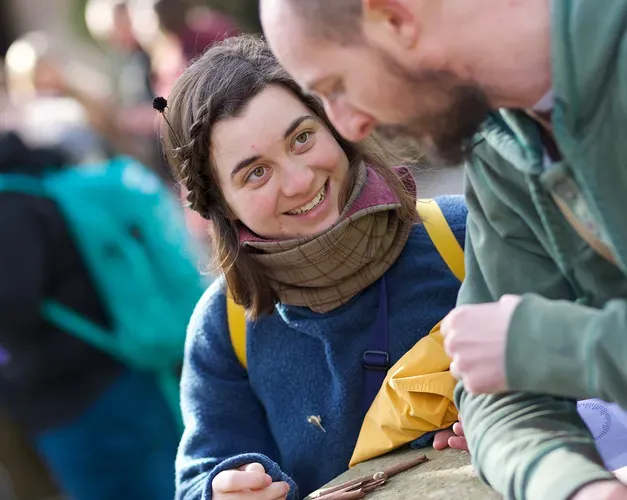 A student smiling and talking