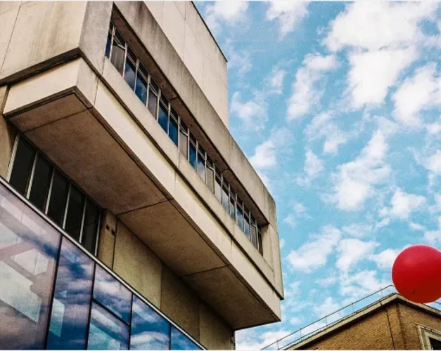 Concrete building with blue sky and clouds