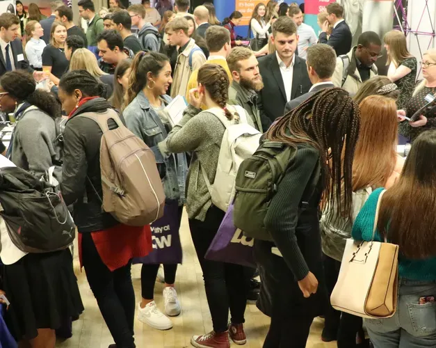 People wearing bags in crowded room