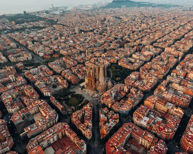 Aerial photograph of Barcelona showing the distinctive grid pattern with Basílica de la Sagrada Família in the middle