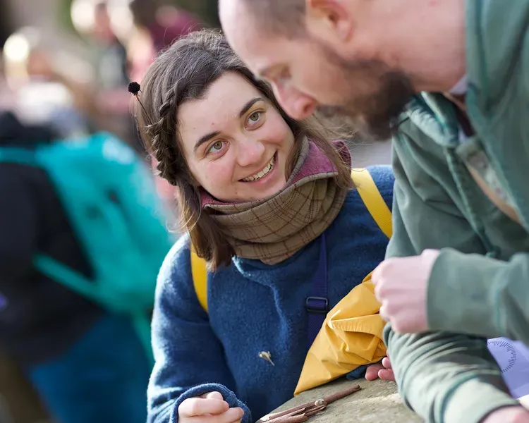 A student smiling and talking