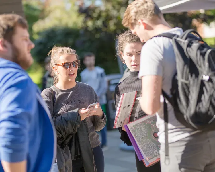 a group of student standing outside