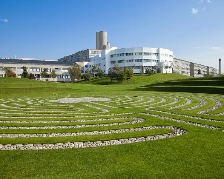 white building behind green grass