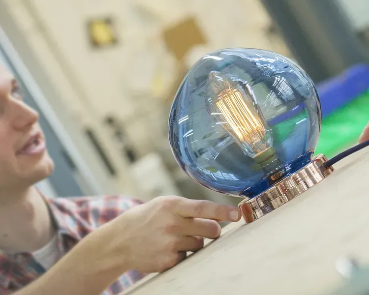 Student with large blue light bulb
