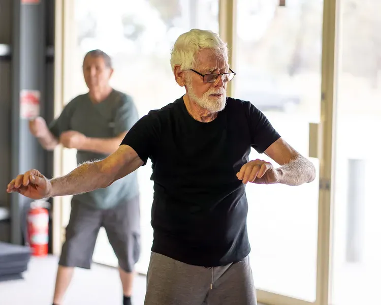 An elderly person in an exercise class