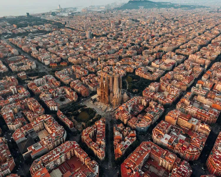 Aerial photograph of Barcelona showing the distinctive grid pattern with Basílica de la Sagrada Família in the middle