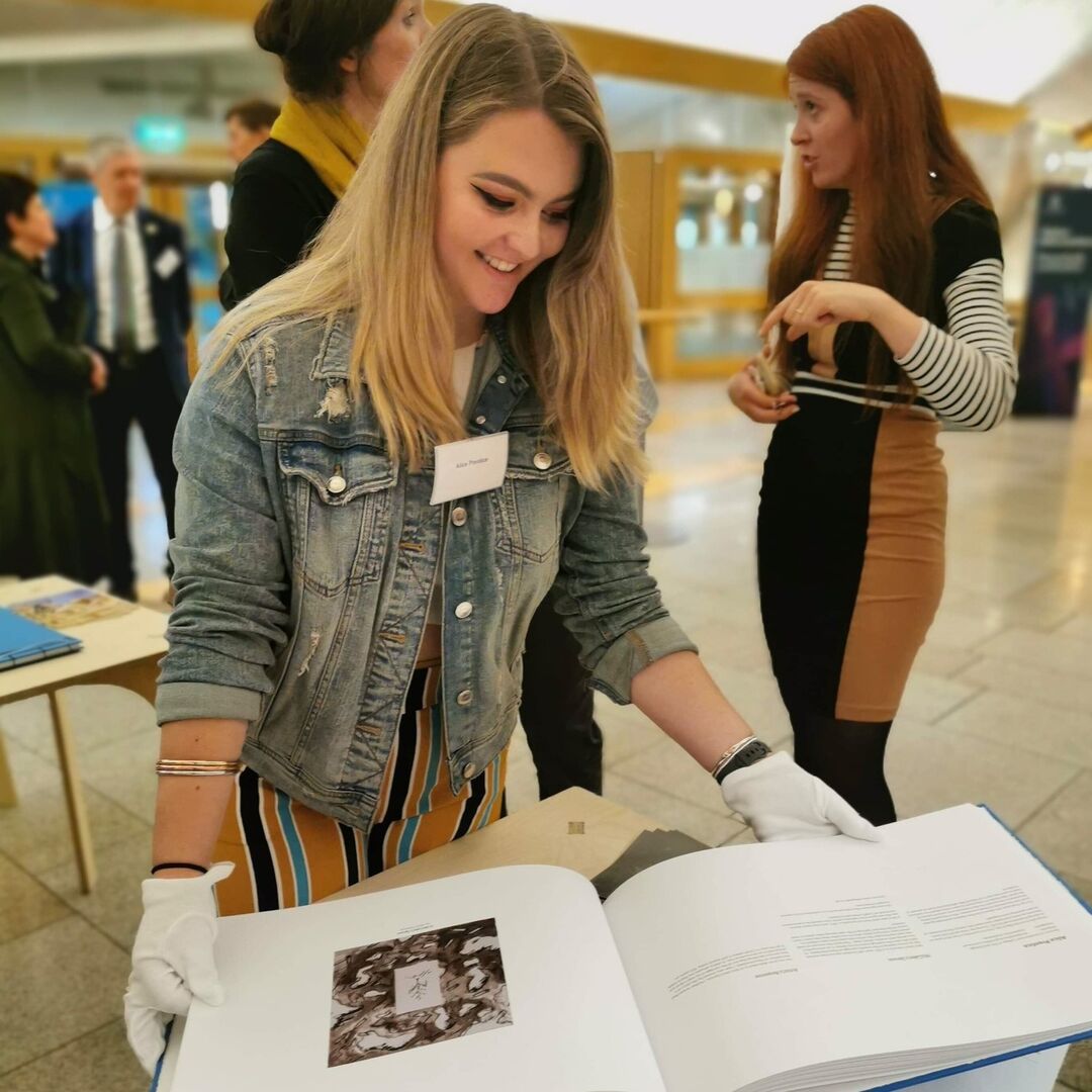 Student opening book with feature image