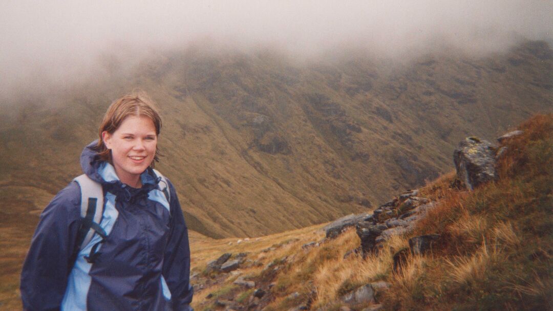 Sheryl Bartlett stands on a misty mountainside.