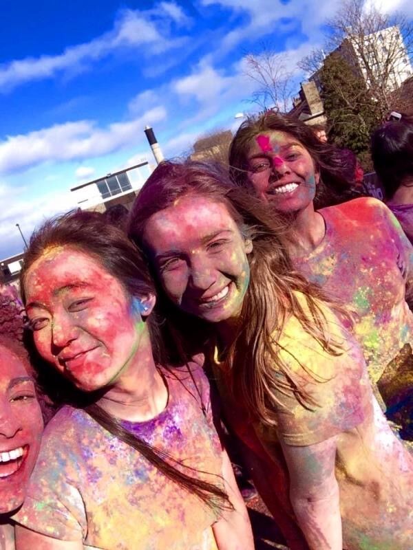Jacqueline Wane and two friends covered in paint powder.