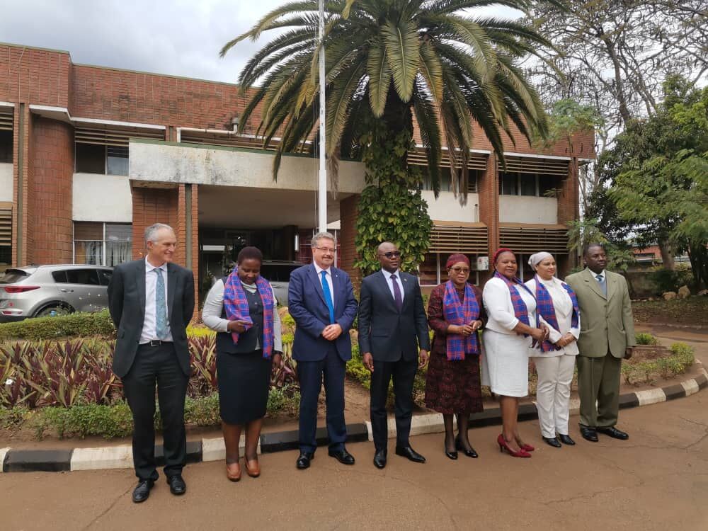 Professors Iain Gillespie and Paul van Gardingen, meeting with six representatives of our Malawian partners, four of whom are wearing scarves in the blue Dundee tartan.