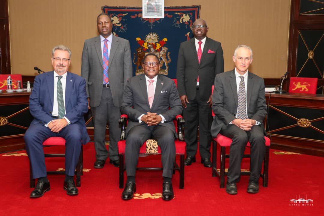 Professors Iain Gillespie and Paul van Gardingen, sit with His Excellency, Dr Lazarus McCarthy Chakwera, President of Malawi