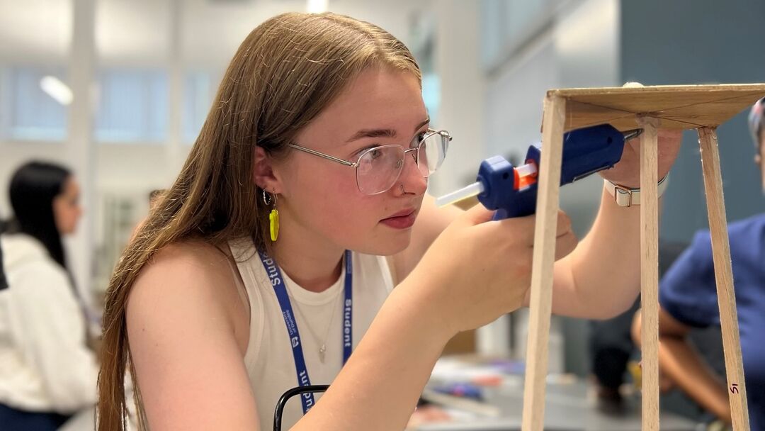 Jessica Paterson gluing together pieces of wood at one of the EMBEDD programme activities