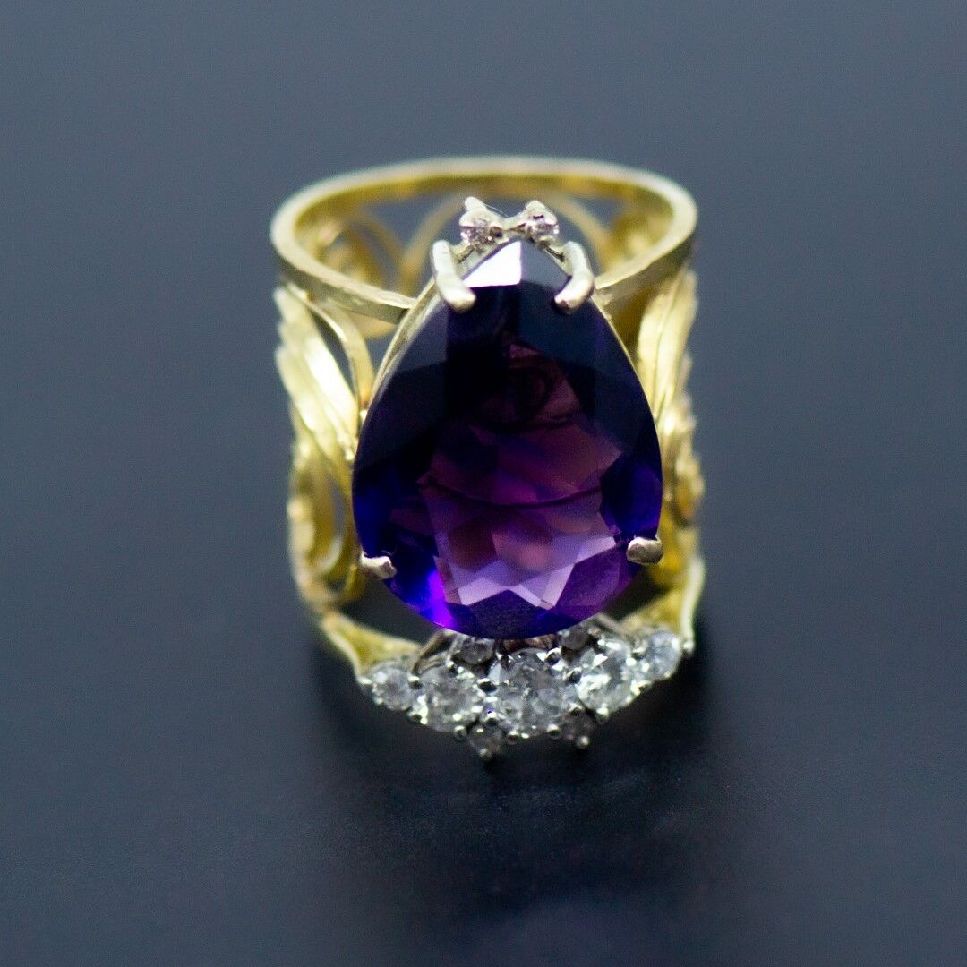 Gold ring with large purple stone and diamonds 