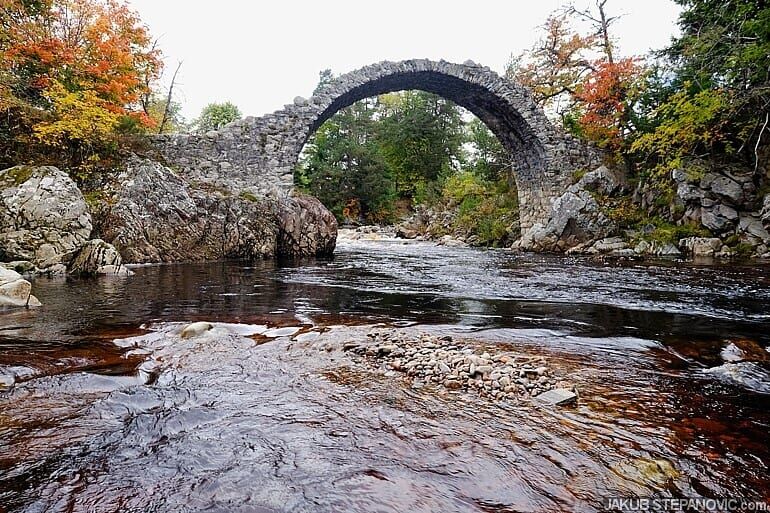 old humped bridge over river