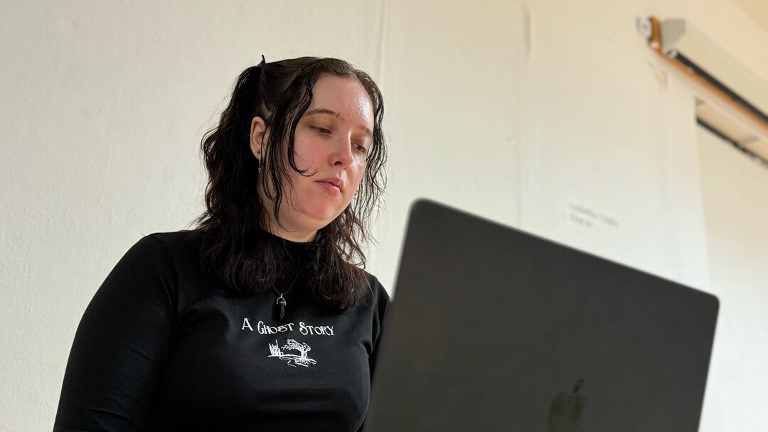 Leah working on a laptop