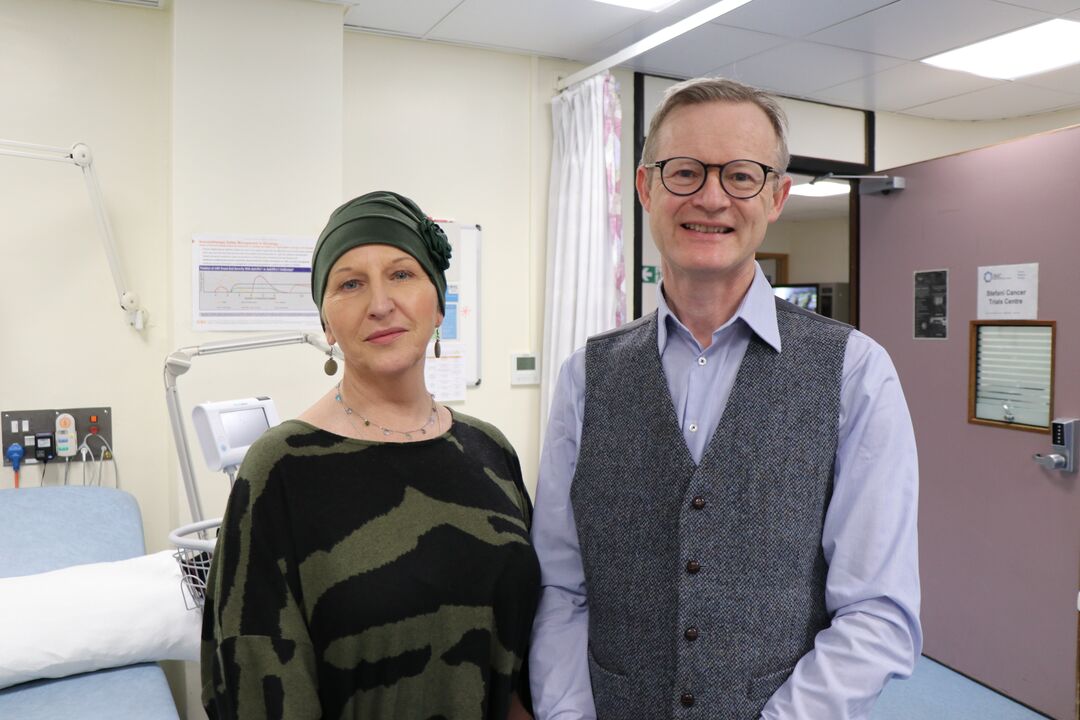 woman on left hand side and man on right hand side, both standing in a hospital room.
