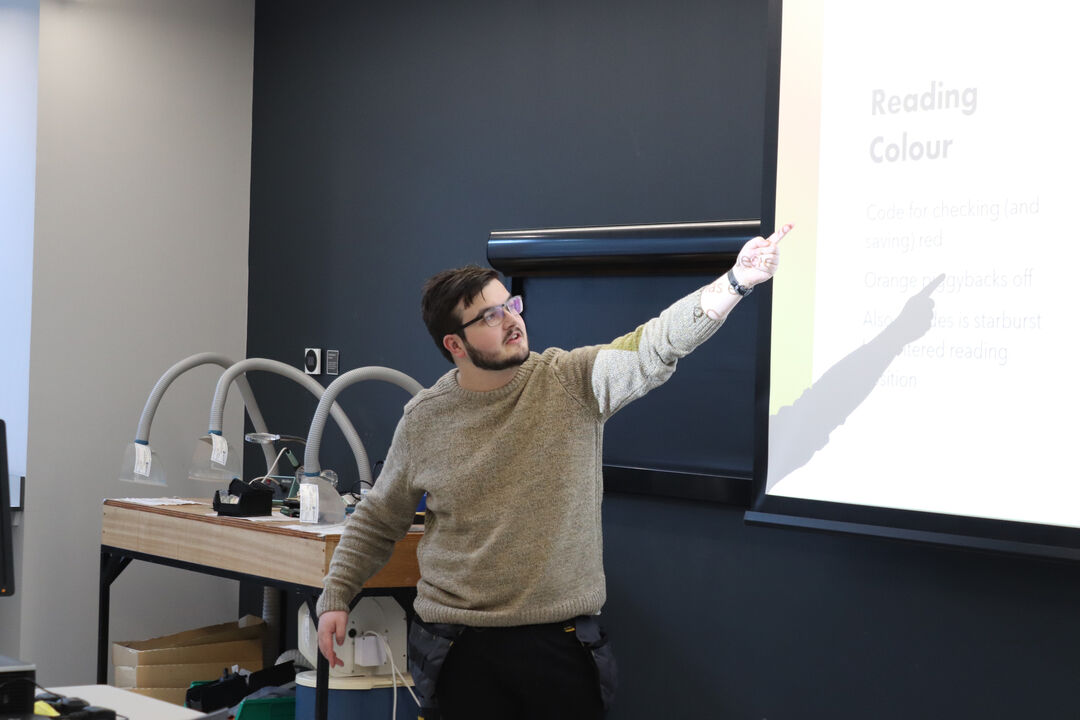 Undergraduate engineering student at the University of Dundee presenting their findings on display screen.