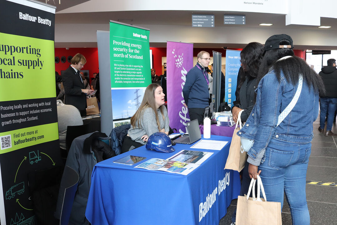 Students gathered at a display stand for the SSEN Careers Expo